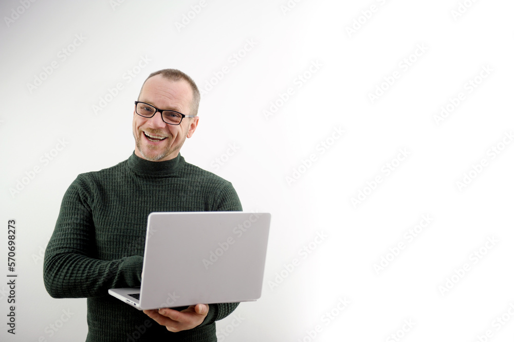 middle-aged man balding in glasses holding laptop joyful fun he shows his feelings to others he is a professor in a dark green golf radiates vibes of joy to students a lecture for lectures with laptop middle-aged man balding in glasses holding laptop joyful fun he shows his feelings to others he is a professor in a dark green golf radiates vibes of joy to students a lecture for lectures with laptop