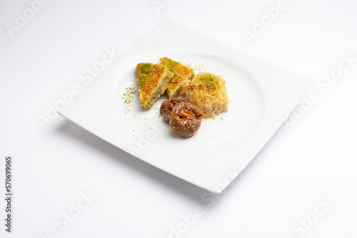 Baklava, kadaif and fig dessert in a white plate photo