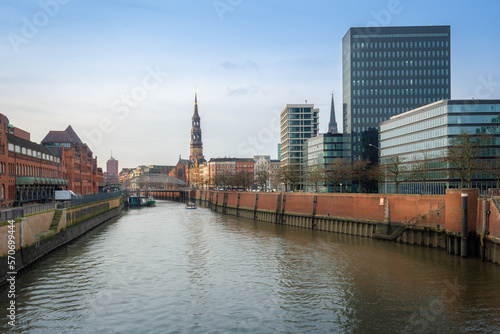 Zollkanal canal at Speicherstadt and Hamburg skyline with St. Catherine Church - Hamburg, Germany