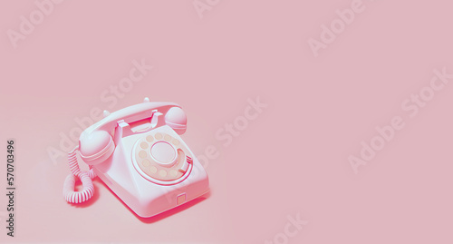 Pink  rotary telephone on light pink background. Space for text on the right