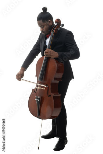 Full length portrait of a african american musician in a black suit and bow-tie playing a cello isolated on white background