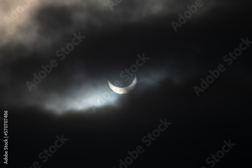 partial sun eclipse with mysterios clouds photo