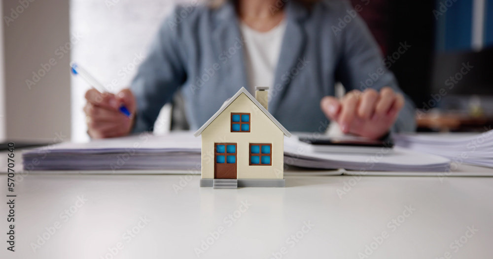 Person Hand Doing Property Tax Calculation Using Calculator Person Hand Doing Property Tax Calculation Using Calculator