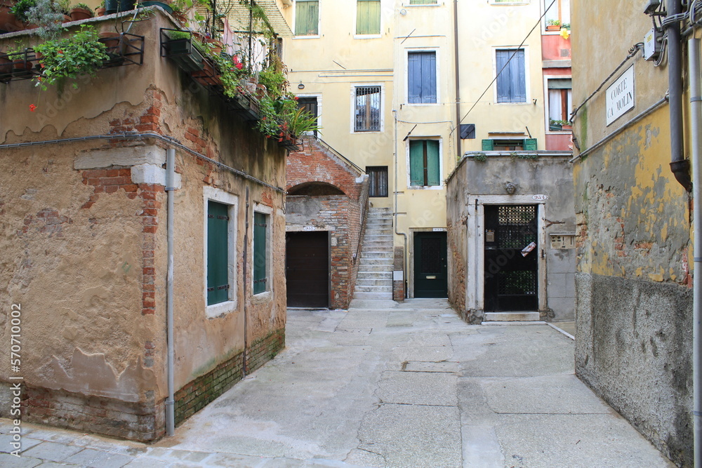 Cute little courtyard between old buildings in Venice, Italy