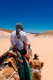 girl riding a camel in the desert of egypt