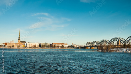 riga, panorama of the city, in the background the blue sky in the foreground is the river © fotofotofoto