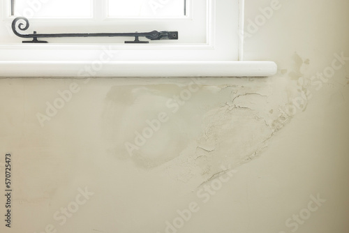 Damp patch on wall, rain penetrating brickwork of old UK house