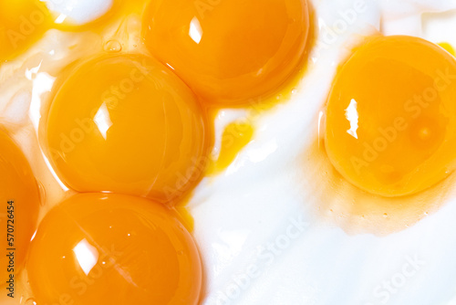 Egg yolks on whipped egg white foam. Close-up of broken eggs. photo