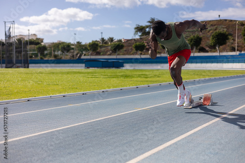 African runner starting a race on an athletics track © javgutierrez