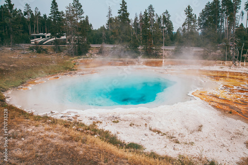 Epic scenic view of colorful steaming pool of geysers in Yellowstone National Park.