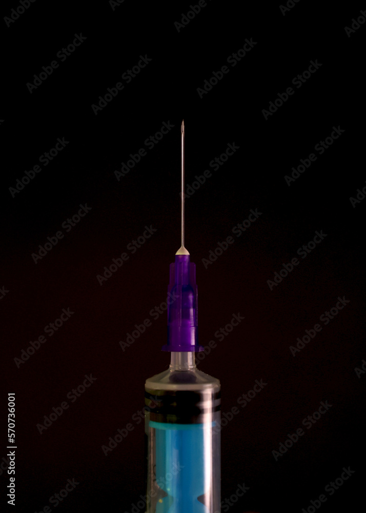 Medicine, syringe on a black background. A sharp syringe needle. Medical equipment. Treatment, overdose. Virus vaccine Medicine, syringe on a black background. A sharp syringe needle. Medical equipment. Treatment, overdose. Virus vaccine