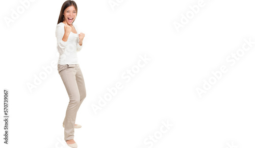 Full length portrait of energetic young woman clenching fists standing isolated over white background.. Isolated cut out in transparent PNG file