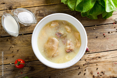 Khashlama with lamb on old wooden table, soup hash, khash photo