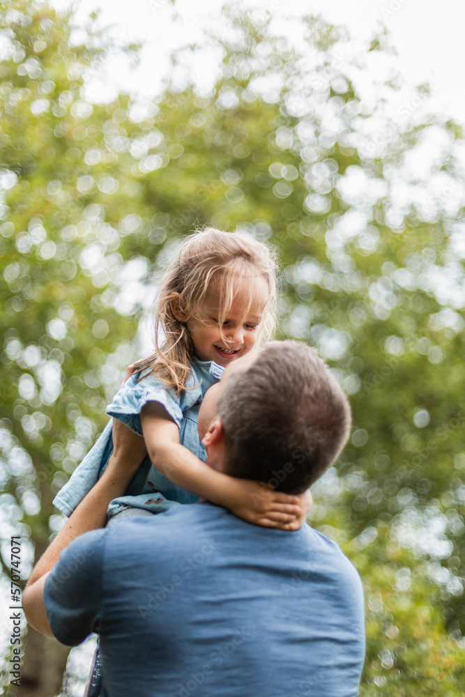 Little girl playing outside in park with her father Little girl playing outside in park with her father