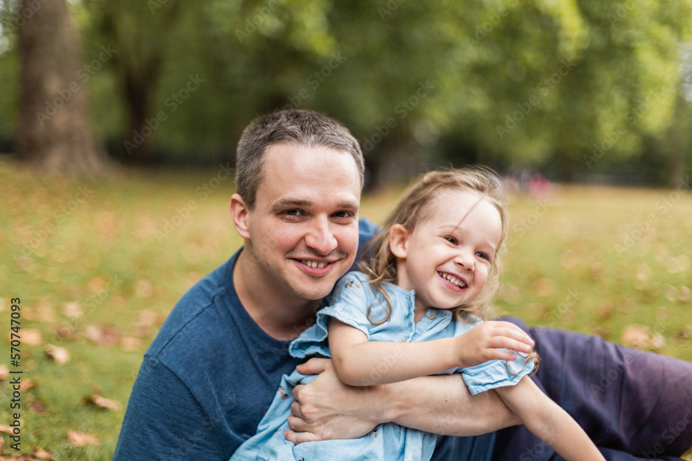 Little girl playing outside in park with her father Little girl playing outside in park with her father
