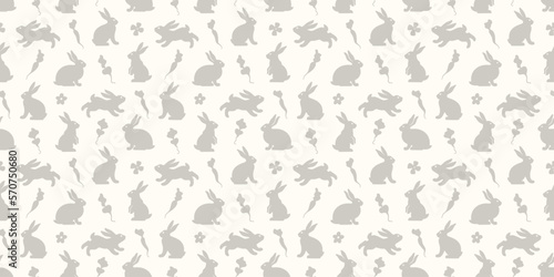 Hand drawn seamless pattern with cute doodle silhouette bunnies. Easter background. Perfect for textile or paper wrapping design. Vector illustration © irenemuse