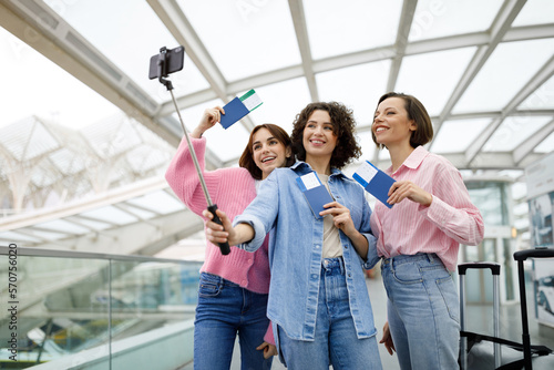Portrait Of Three Happy Women Taking Photo Together At Airport