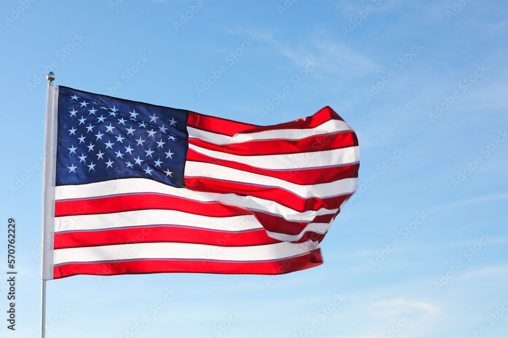 Naklejka premium American flag fluttering outdoors on sunny day
