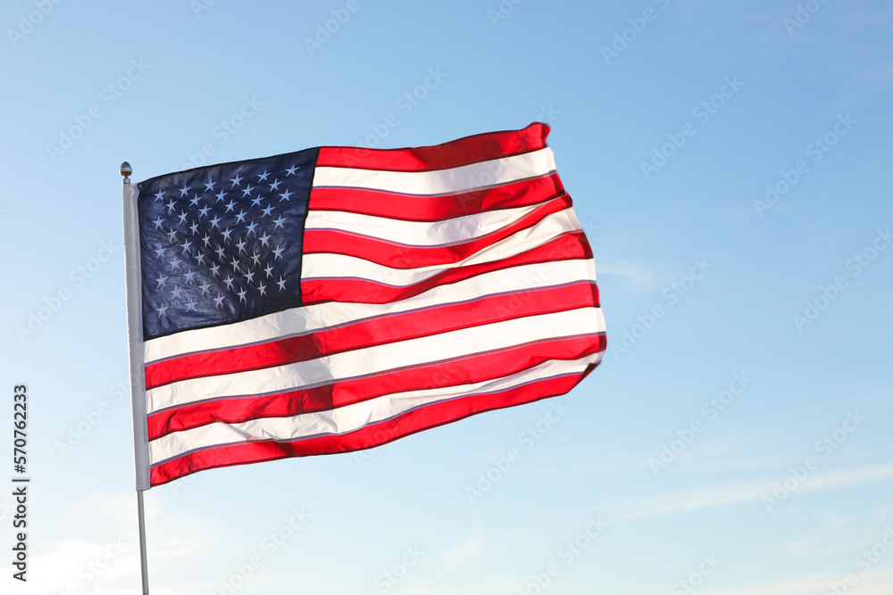Obraz premium American flag fluttering outdoors on sunny day