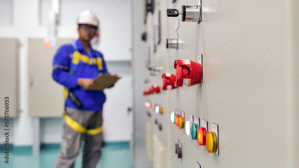 Within the substation building, engineers regularly examine electrical equipment and some parameter settings to make sure everything is in working order. industrial and technological concept Within the substation building, engineers regularly examine electrical equipment and some parameter settings to make sure everything is in working order. industrial and technological concept