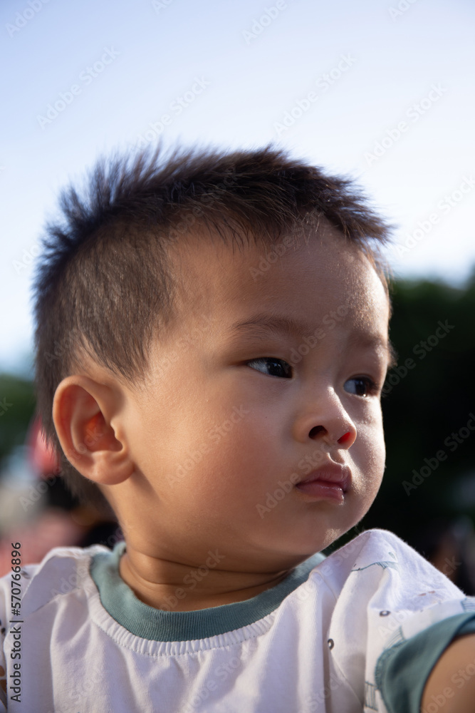 Close up portrait of Asian boy in the sunset