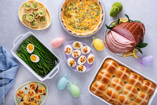 Wall Mural Easter brunch table with ham, quiche, hot cross buns