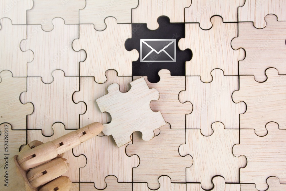 wooden puzzle with an unopened Email icon. email support concept. the concept of email and the concept of communication through email wooden puzzle with an unopened Email icon. email support concept. the concept of email and the concept of communication through email