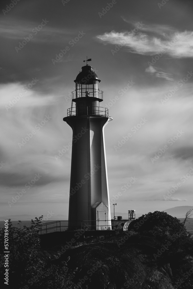 Black and white lighthouse on the coast of Pacific ocean