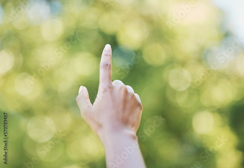 Hand, index finger and pointing in nature, outdoors or at park at something. Direction, bokeh and hands point up for gesture, signal or sign language, counting fingers or emoji, mathematics or timer.