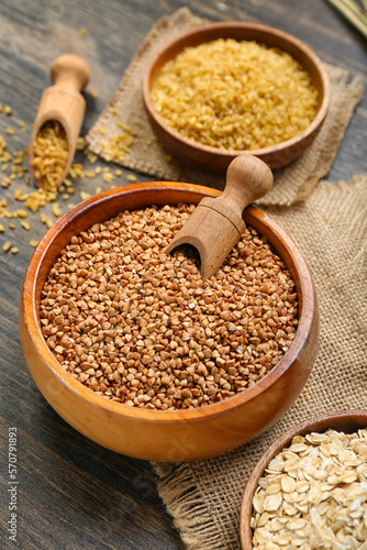 Bowl of buckwheat on dark wooden background, closeup