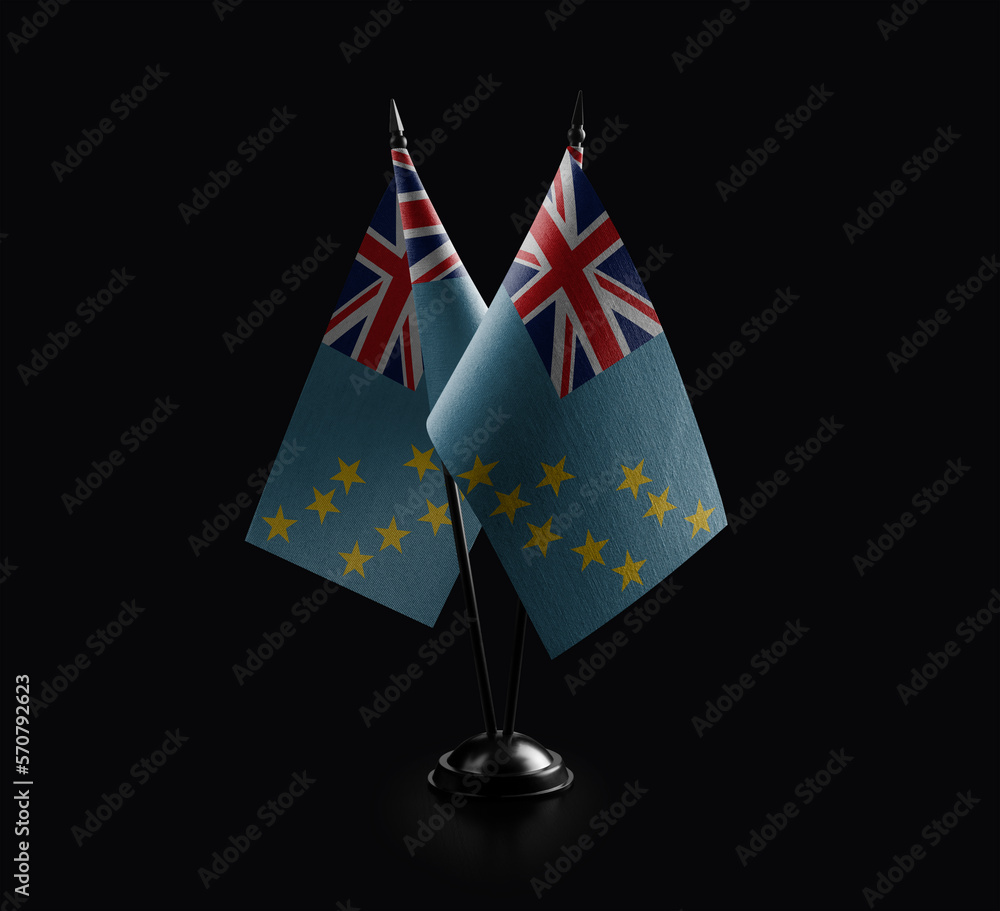 Small national flags of the Tuvalu on a black background