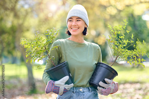 Plants, gardening and woman volunteering for agriculture, growth project and sustainability on earth day. Park, natural environment and community service worker, farmer or person with trees in forest