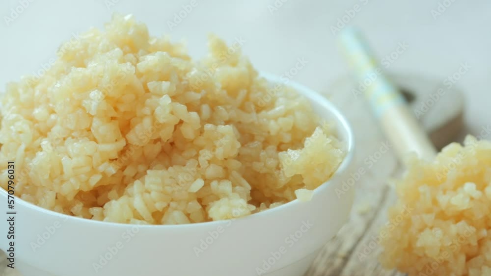 close up of minced garlic on a wooden spoon close up of minced garlic on a wooden spoon