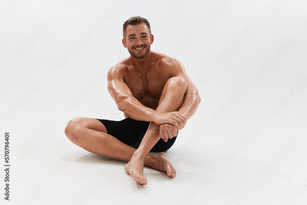 Man athletic body bodybuilder in briefs with naked torso abs full-length in the background, fitness classes. Advertising, sports, active lifestyle, competition, challenge concept. Man athletic body bodybuilder in briefs with naked torso abs full-length in the background, fitness classes. Advertising, sports, active lifestyle, competition, challenge concept.