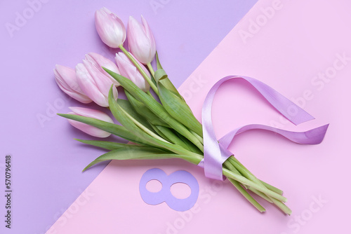 Bouquet of beautiful tulip flowers and paper figure 8 on color background. Women s Day celebration