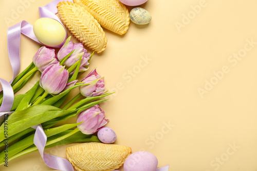 Tulips with eggs and shekarbura on beige background. Novruz Bayram celebration photo