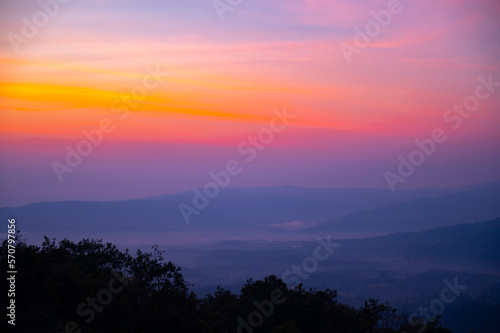 Layer background of Aerial view sunset , sunrise over dark mountain with fog over the ground.The early evening sun illuminates the mountains and valleys.