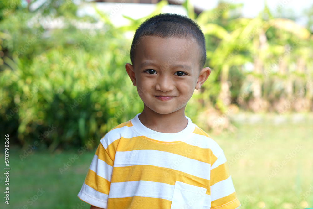 Asian boy smiling happily in the garden Asian boy smiling happily in the garden