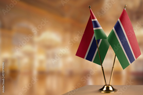 Small flags of the Gambia on an abstract blurry background