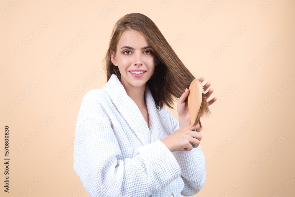 Studio portrait of attractive pretty haired girl combing hair. Hair care, hairs salon. Beautiful woman with healthy skin straight hair isolated on studio background. Hairs day. Beautiful smooth hair. Studio portrait of attractive pretty haired girl combing hair. Hair care, hairs salon. Beautiful woman with healthy skin straight hair isolated on studio background. Hairs day. Beautiful smooth hair.