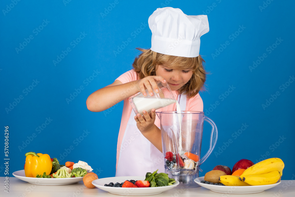 Chef kid boy making fresh milk shake smoothie for healthy eat. Portrait of little child in form of cook isolated on grey background. Kid chef. Cooking process. Chef kid boy making fresh milk shake smoothie for healthy eat. Portrait of little child in form of cook isolated on grey background. Kid chef. Cooking process.