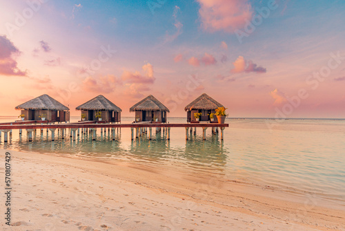 Amazing beach landscape. Beautiful Maldives sunset seascape view. Horizon colorful sea sky clouds, over water villa pier pathway. Tranquil island lagoon, tourism travel background. Exotic vacation 
