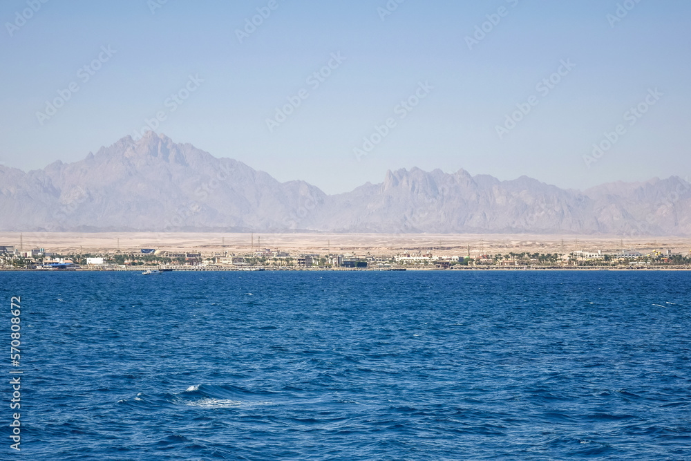 Obraz premium Picturesque view of coast from sea. Vacation in Egypt. Copy space. Selective focus.