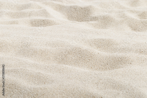 Beige Sand texture natural background. Close up waves pattern on sand dunes, light pastel color, minimal nature backdrop, beautiful beach. Summer and travel, spa and relax concept. Selective focus.