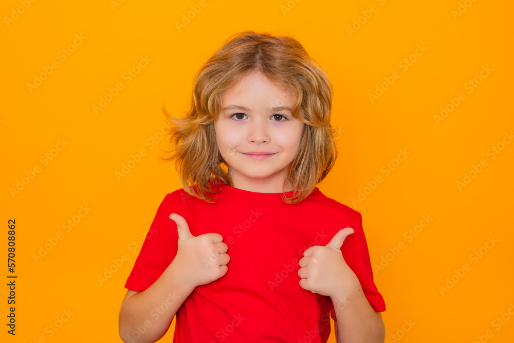 Child showing thumbs up on studio isolated background. Portrait of kid ...