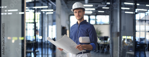 Shot of male architect wearing hardhat and inspecting new building.