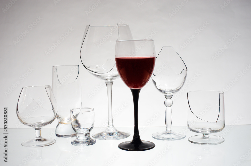 A glass of wine and broken glasses. Stop alcohol symbol. A glass of wine and broken glasses. Stop alcohol symbol.
