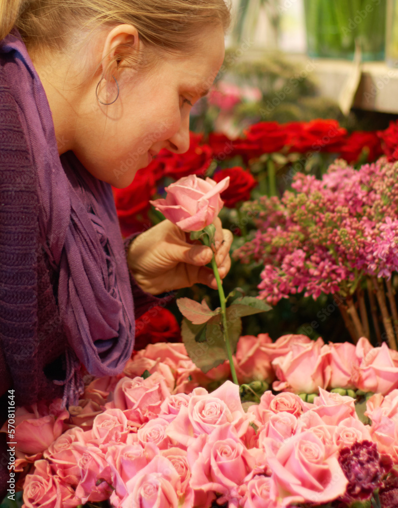 Woman, smelling roses and retail for floral bouquet for scent, color and shopping for valentines day gift. Flowers, leaves and sustainable plants for beauty, present and sale in startup florist store