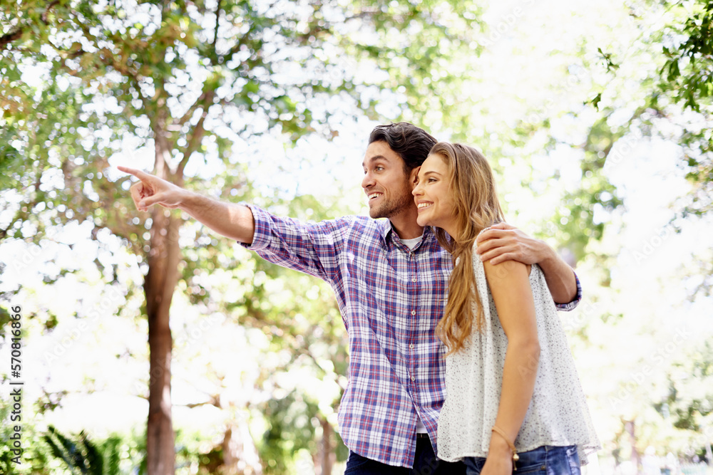 Couple, park and date of a woman and man together with love, care and hug in nature. Green trees, sunshine and happy people outdoor excited by pointing in the sun with happiness and good mood Couple, park and date of a woman and man together with love, care and hug in nature. Green trees, sunshine and happy people outdoor excited by pointing in the sun with happiness and good mood