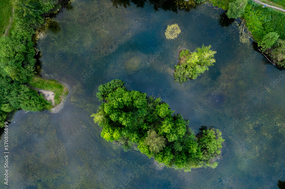summer view from the drone on lonely island standing on the calm water of the lake summer view from the drone on lonely island standing on the calm water of the lake